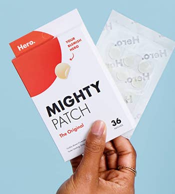 person holding pack of 36 circular Mighty Patches on a plastic adhesive strip