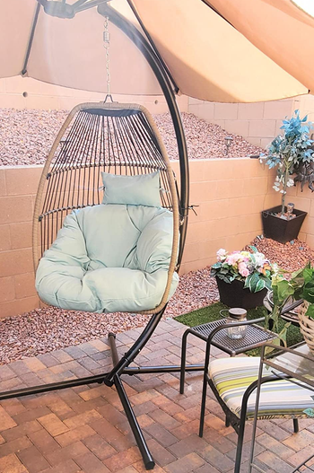 reviewer photo of the light blue  and black chair on a patio