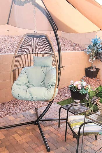 reviewer photo of the light blue  and black chair on a patio