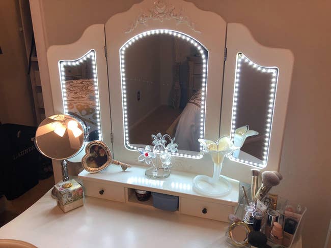 reviewer's three-section vanity showing all three mirrors outlined with the lights