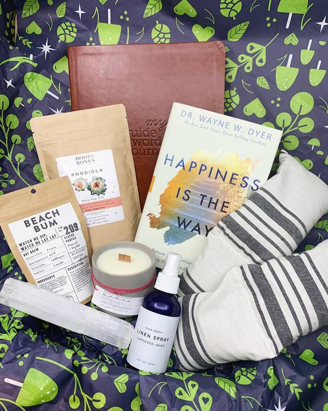 Image of the gift box with linen spray, tea, a candle, and more
