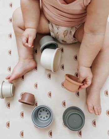 reviewer's baby playing with cups
