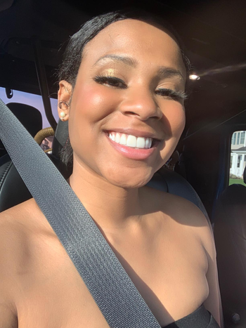 reviewer with bright and glowing skin around cheeks and forehead wearing the C.E.O. Glow Face Oil