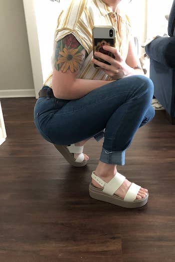 Reviewer wearing white  Croc sandals