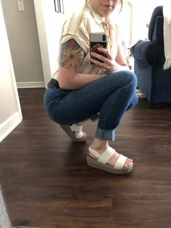 Reviewer wearing white  Croc sandals