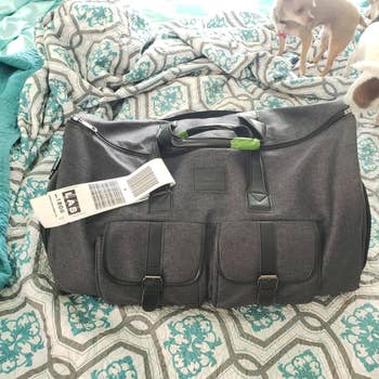 Reviewer image of gray duffle bag on top of bed