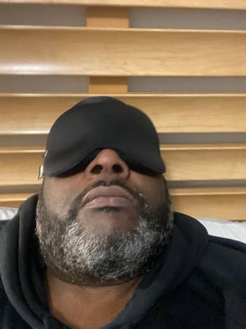 a reviewer wearing the sleep mask in black