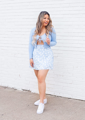 reviewer wearing the skirt in light blue with white flowers