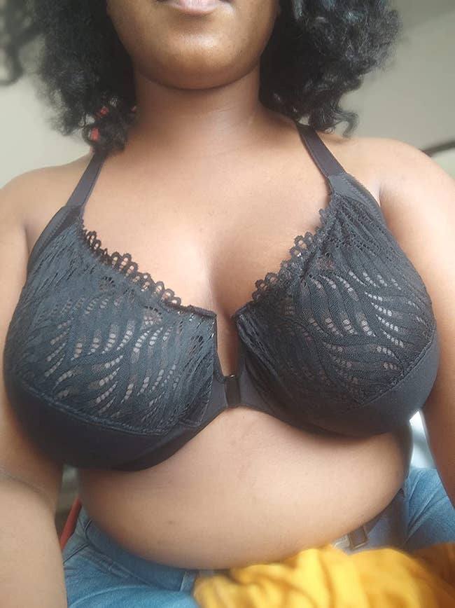 A close up of a reviewer wearing the black bra
