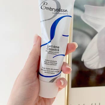 image of reviewer holding up tube of cream