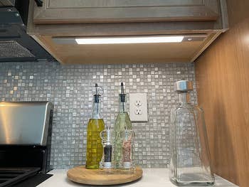 the under cabinet light applied under a cabinet in a kitchen