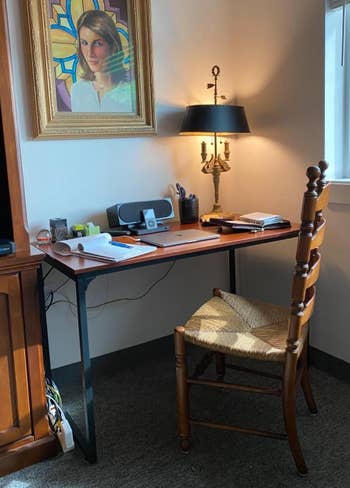 reviewer's brown desk in a corner
