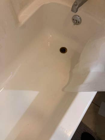 The same bathtub after using the cleaner, now clean and spotless
