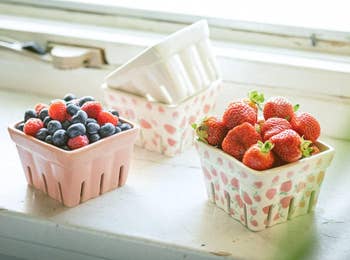 Assorted caller berries successful decorative baskets connected a windowsill