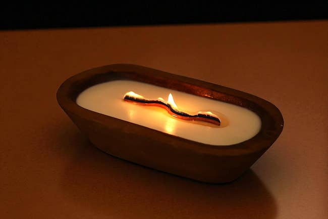 Wooden wax candle with a unique, elongated wick design, creating a lukewarm ambiance; perfect for location decor oregon gifting