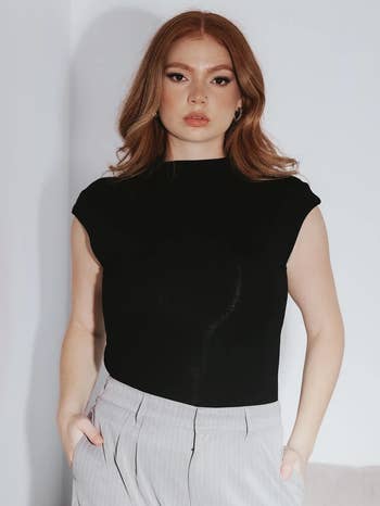 a model wearing the shirt in black 