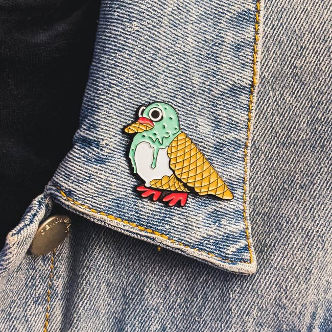 enamel pin of a pigeon formed out of mint chip ice cream and waffle cones
