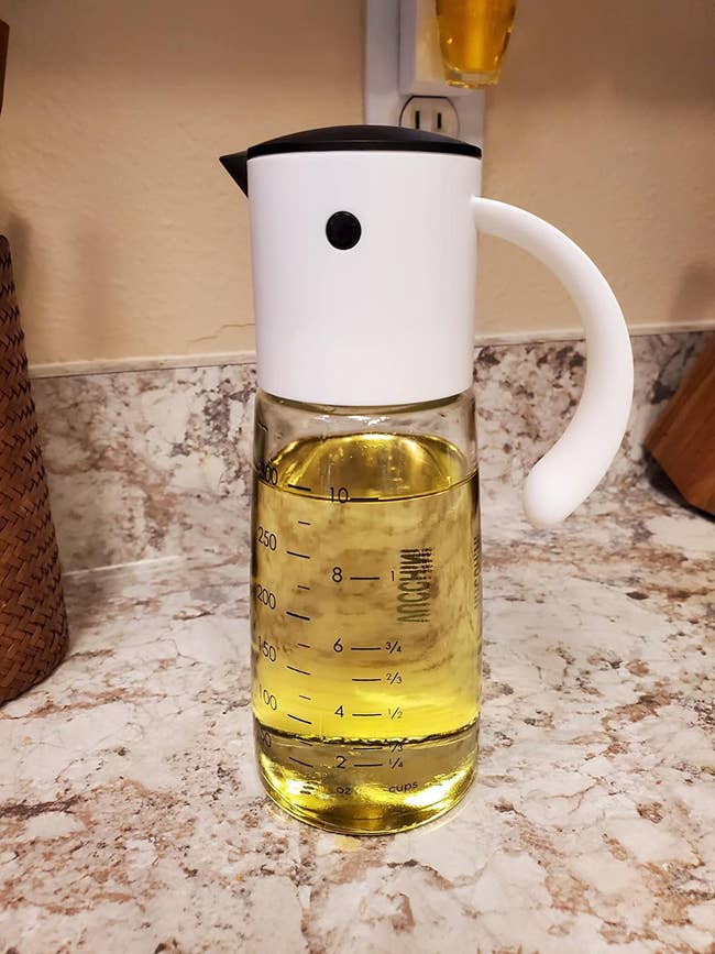 reviewer's oil dispenser with a top that looks like a bird