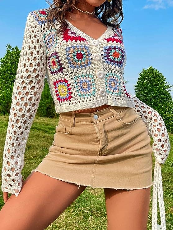 a model wearing the buttoned-up sweater in white and multicolor  