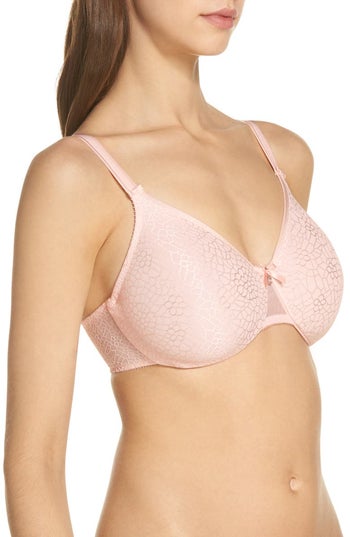 Model wearing the pink floral minimizer bra, slightly turned sideways