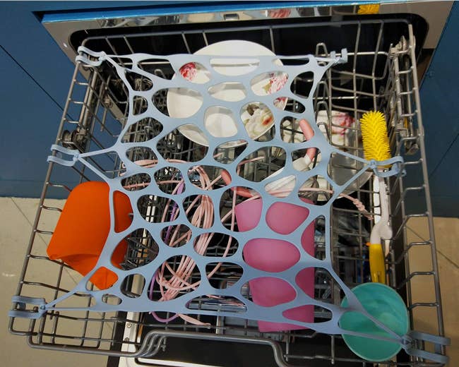 open top rack of dishwasher with net keeping stuff in place