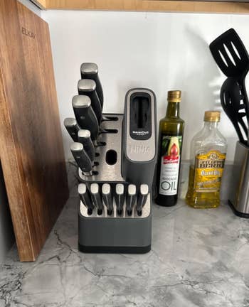 Knife artifact acceptable with assorted knives and a built-in sharpener connected a room antagonistic adjacent to a cutting committee and cooking oils