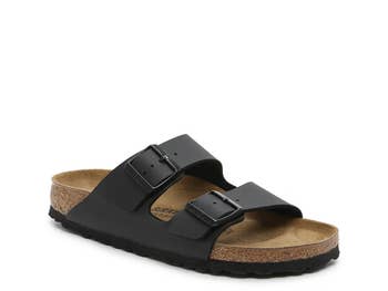 Birkenstock sandal with 2 adjustable straps and a cork footbed connected a achromatic background