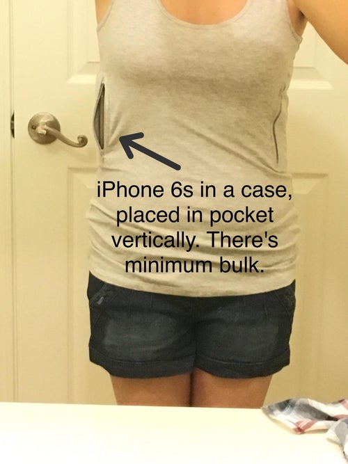 reviewer showing the tank with a phone in the pocket