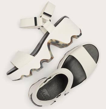 Platform sandals with sculpted soles and adjustable straps displayed broadside by side