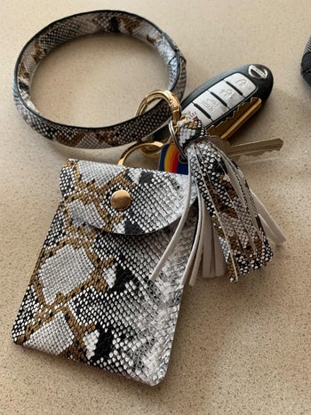 A reviewer's snakeskin key wristlet