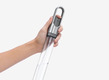 Model holding the spray bottle from inside the holder