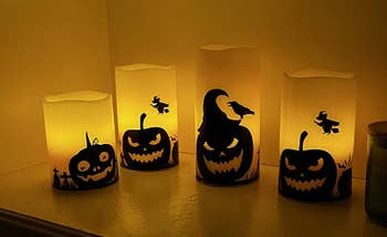 four candles with pumpkin themes in review photo 