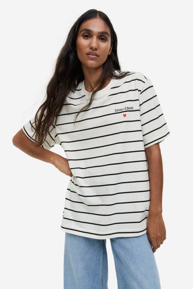 model wearing the white shirt with black stripes