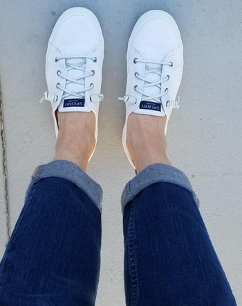 reviewer's feet in the white sneakers