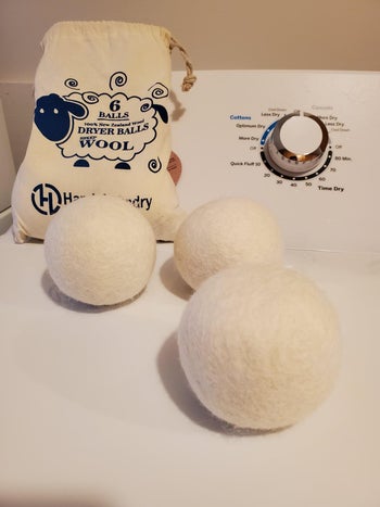 the same dryer balls on top of a white washing machine