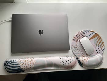 reviewer photo of macbook air with wrist rest and mouse pad with wrist support