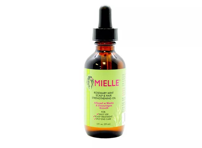 A rosemary and mint scalp & hair strengthening oil in a green and dark brown bottle. 