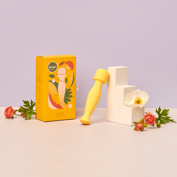 Vibrator next to box and flowers on disply