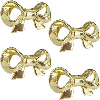 Four golden bow-shaped drawer pulls
