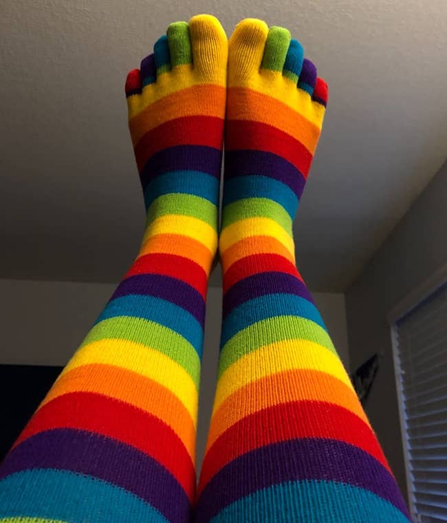 Image of reviewer wearing colorful striped toe socks