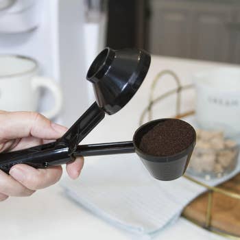 the scooper filled with coffee grounds