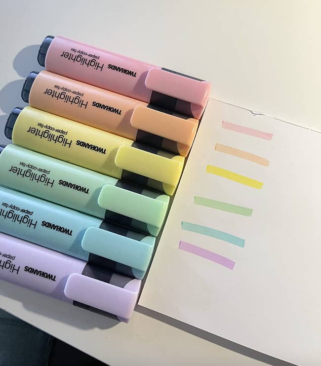 Reviewer pic of purple, blue, green, yellow, orange, and pink pastel highlighter ink on paper