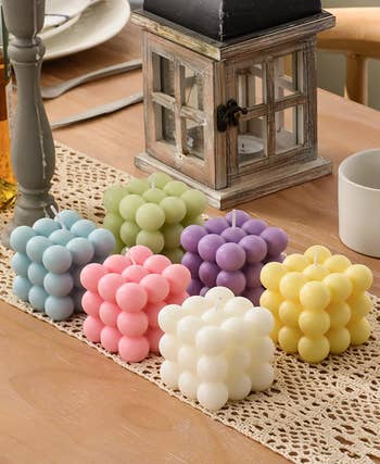 six bubble candles in blue, green, pink, purple, yellow, and white