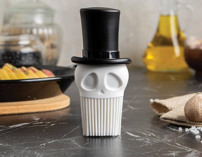 a basting brush that looks like a skeleton wearing a top hat