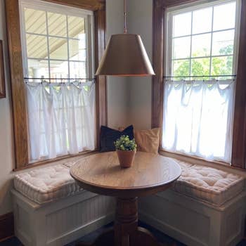 another reviewer's ivory cushions on a bench around a kitchen dining table