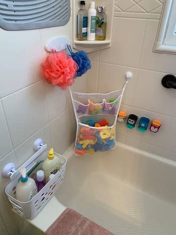 the bath toy organizer suctioned to the corner of a reviewer's shower