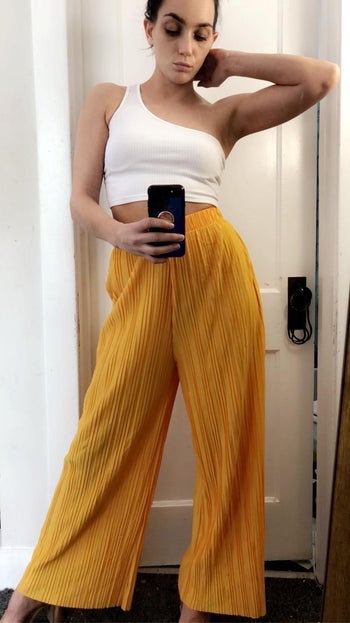 reviewer photo of them posing in the yellow palazzo pants
