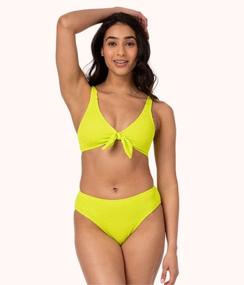 a different model wearing the same swim suit in neon green