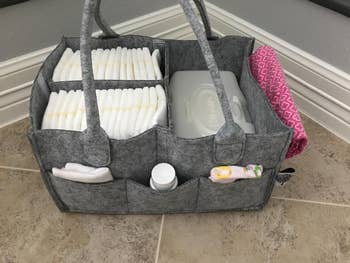 a reviewer's grey organizer filled with babe  supplies