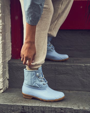 model wearing saltwater duck boots in light blue color